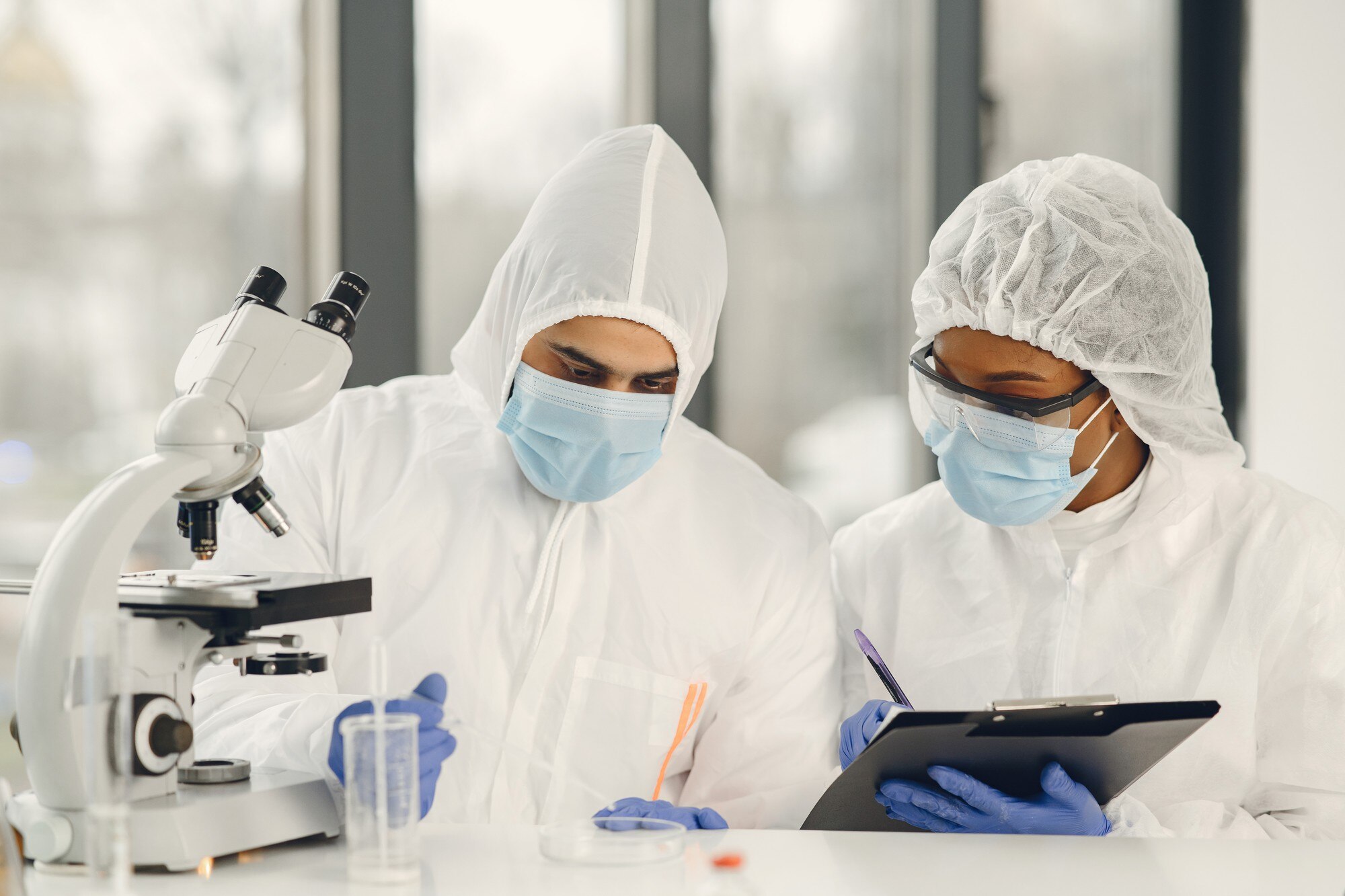 scientists-microbiologists-with-ppe-suit-face-mask-hold-test-tube-microscope-lab-finding-treatment-vaccine-coronavirus-infection-covid-19-laboratory-vaccine-concept_1157-48136